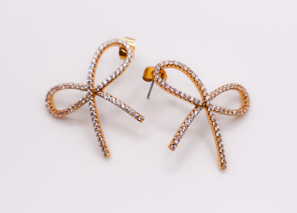Le Réussi® Golden Bow Tie Sparkle Earrings with shimmering gold bow design