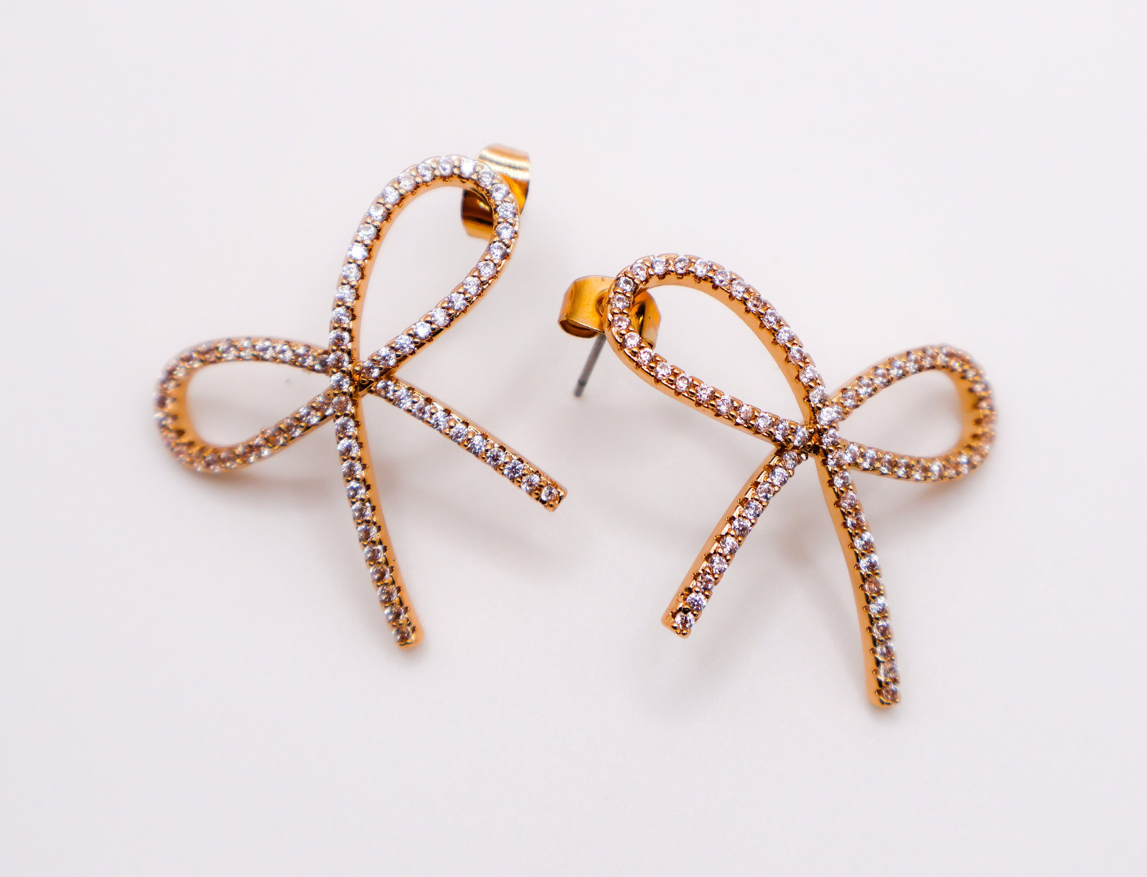 Le Réussi® Golden Bow Tie Sparkle Earrings with shimmering gold bow design