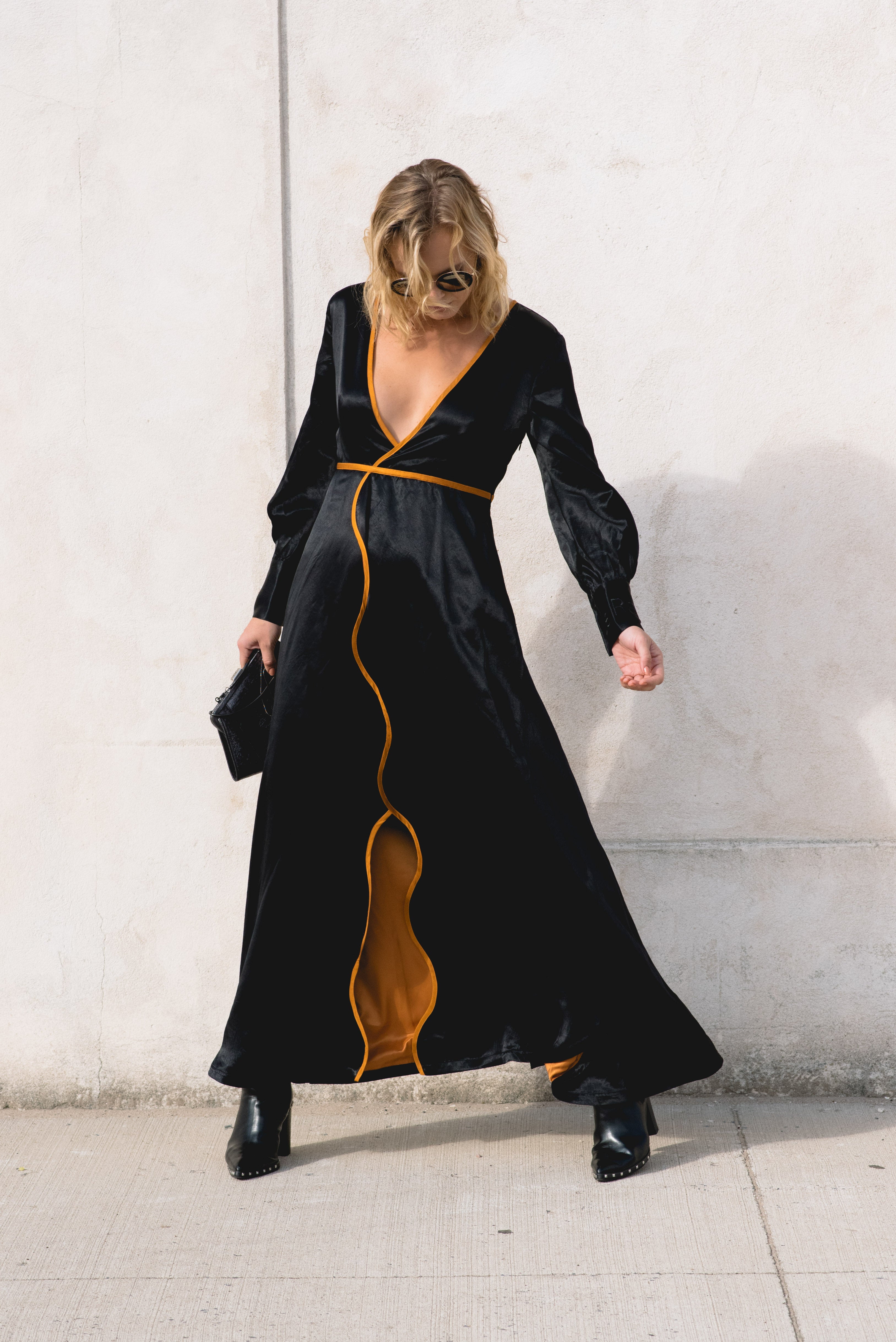 Le reussi Fashion-Adrienne Black Crafted from premium silk and adorned with elegant orange line details,this style dress features a sophisticated v-neck and long sleeves.