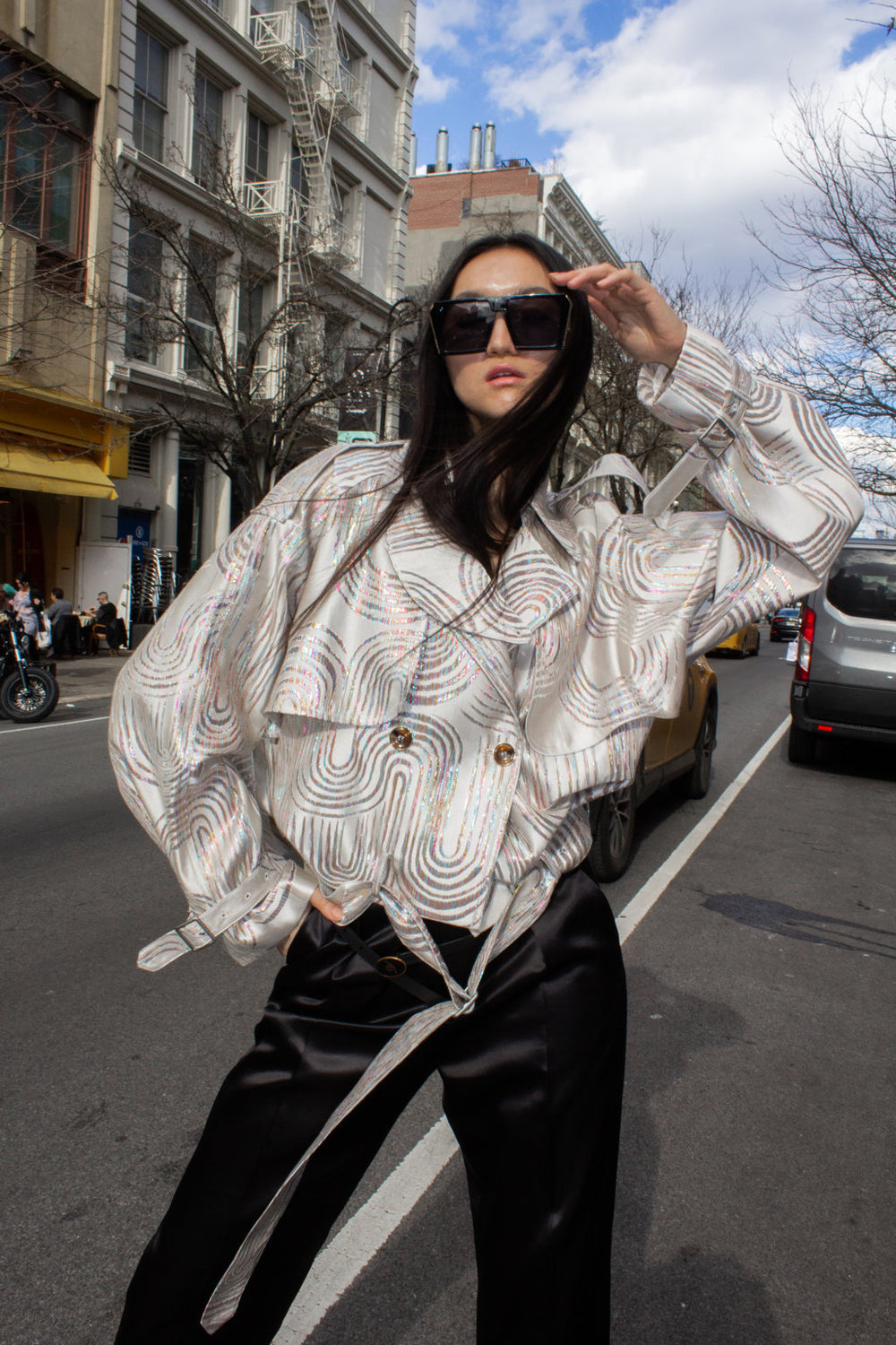 Model wearing Le Réussi® statement outerwear on a city street